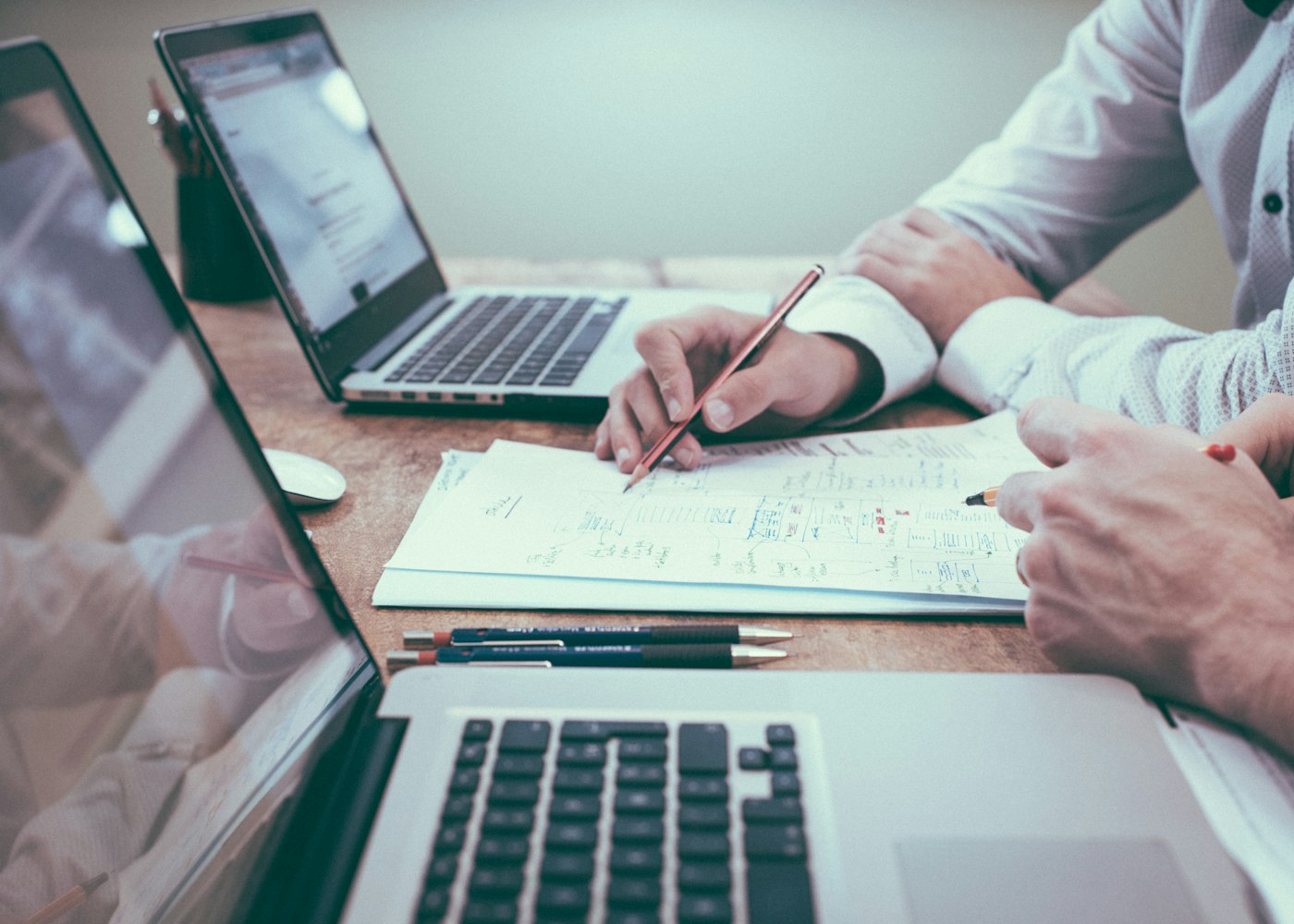 Business owners reviewing performance figures and planning revenue growth